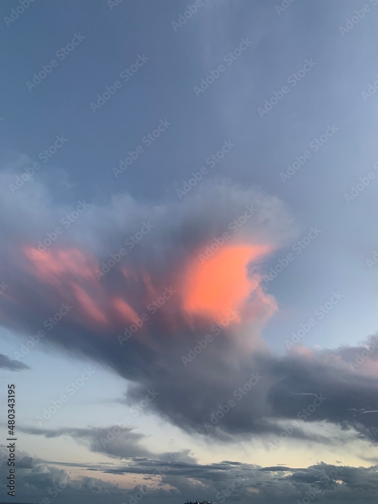 Fantastic colorful clouds in the blue sky, surrealistic nature background 