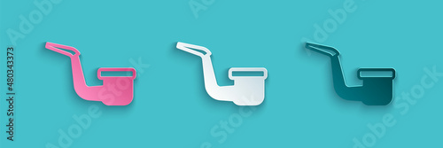 Paper cut Smoking pipe with smoke icon isolated on blue background. Tobacco pipe. Paper art style. Vector