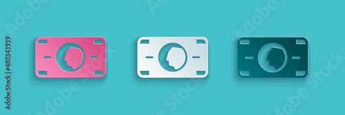 Paper cut Stacks paper money cash icon isolated on blue background. Money banknotes stacks. Bill currency. Paper art style. Vector