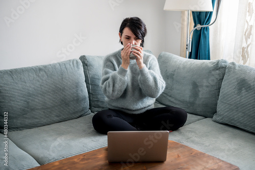Young woman is resting on a sofa