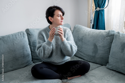 Young woman is resting on a sofa