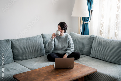 Young woman is resting on a sofa