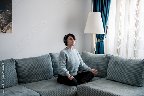 Young woman is resting on a sofa