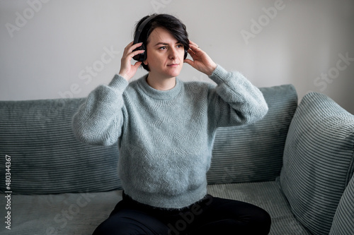 Young woman is resting on a sofa