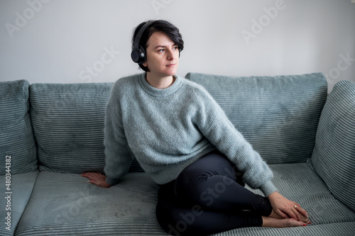 Young woman is resting on a sofa