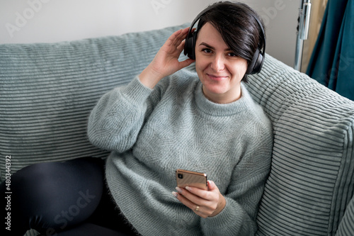 Young woman is resting on a sofa