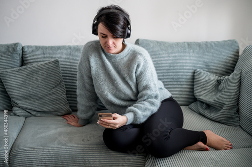 Young woman is resting on a sofa