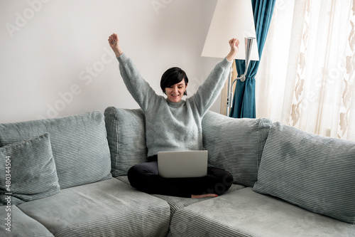 Young woman is resting on a sofa
