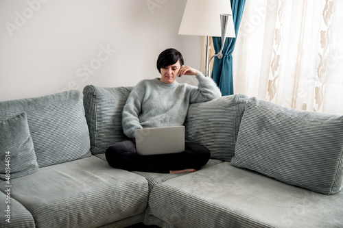 Young woman is resting on a sofa