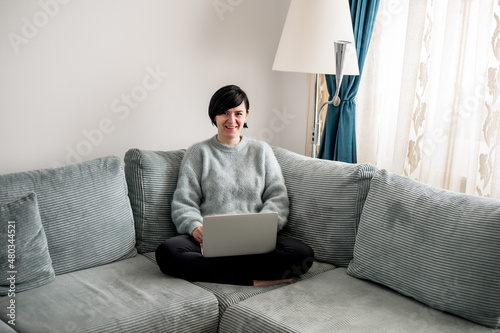 Young woman is resting on a sofa