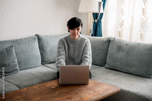 Young woman is resting on a sofa