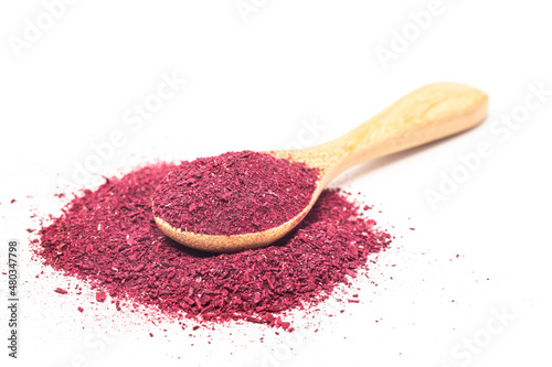 Powder of Roselle flower buds in wooden spoon isolated on white background