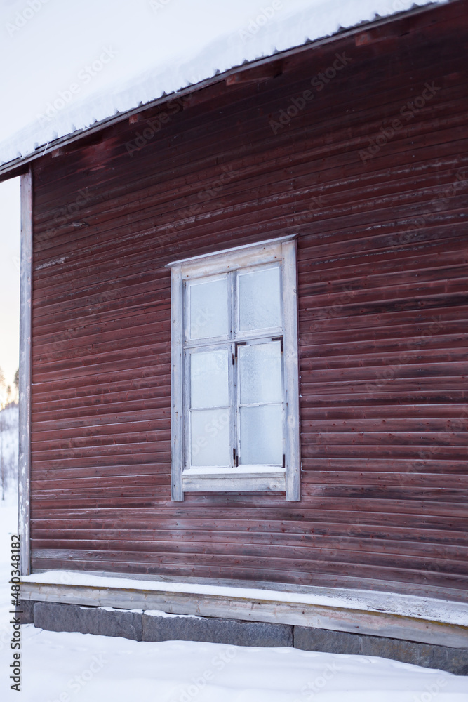 Red wooden building in snowy landscape Red wooden building in snowy landscape
