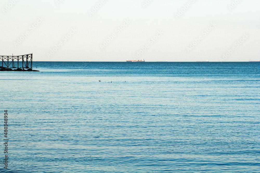 Still clear blue sea and sky background view