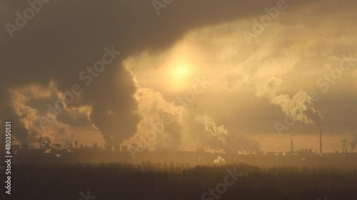 Factory chimneys pollute the air, environmental problems. It's snowing ash at sunset. Industrial pollution, exhaust fumes from the chimney. Industrial area, thick smoke. Climate change, ecology, atmos