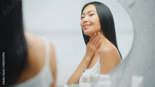 Beautiful Asian Woman Touches Her Perfect Soft Shoulder, Neck, Sensually Smiles in the Mirror. Happy Female Enjoying Her Beauty. Wellness Natural Cosmetic Skincare Products. Free Download Beautiful Asian Woman Touches Her Perfect Soft Shoulder, Neck, Sensually Smiles in the Mirror. Happy Female Enjoying Her Beauty. Wellness Natural Cosmetic Skincare Products. - GFXLoad
