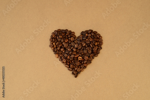 heart shape of roasted coffee beans on the background of kraft paper, coffee valentine coffee lovers