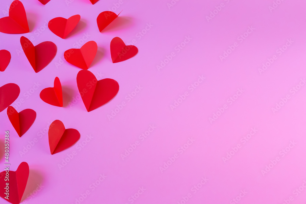 Flying red hearts on a pink background
