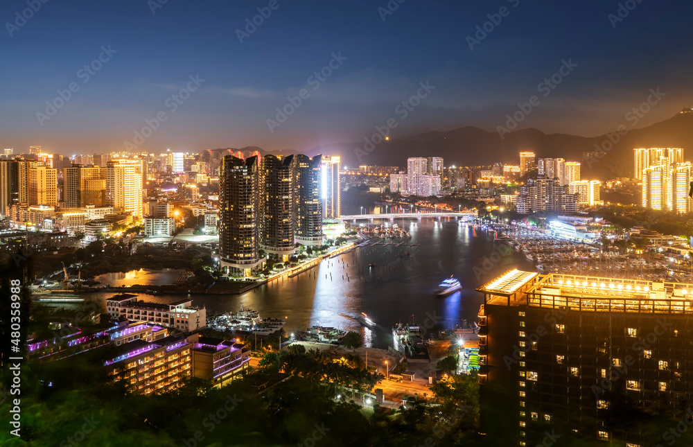 Aerial photography of modern city night view of Sanya, China