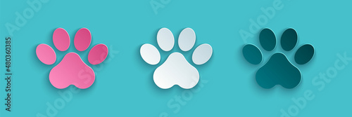 Paper cut Paw print icon isolated on blue background. Dog or cat paw print. Animal track. Paper art style. Vector