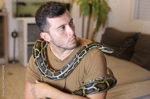 Man with beautiful pet snake 