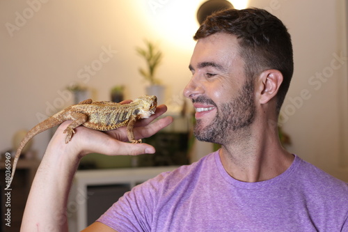 Man petting a bearded dragon