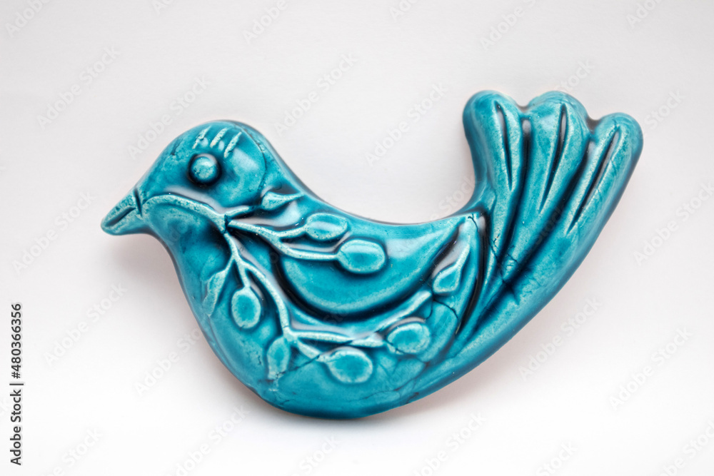 A blue ceramic bird. The blue bird is a symbol of happiness. A blue ceramic bird. The blue bird is a symbol of happiness.