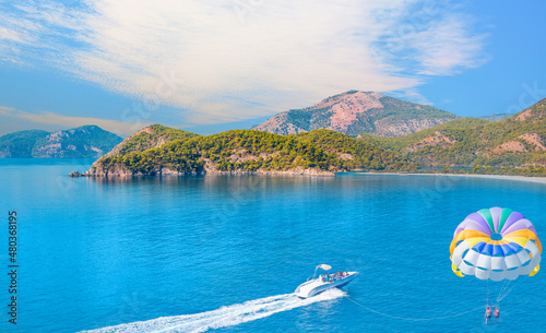 Fototapeta Naklejka Na Ścianę i Meble -  Colorful parasail wing pulled by a boat in the sea - Oludeniz Beach And Blue Lagoon, Oludeniz beach is best beaches in Turkey - Fethiye, Turkey