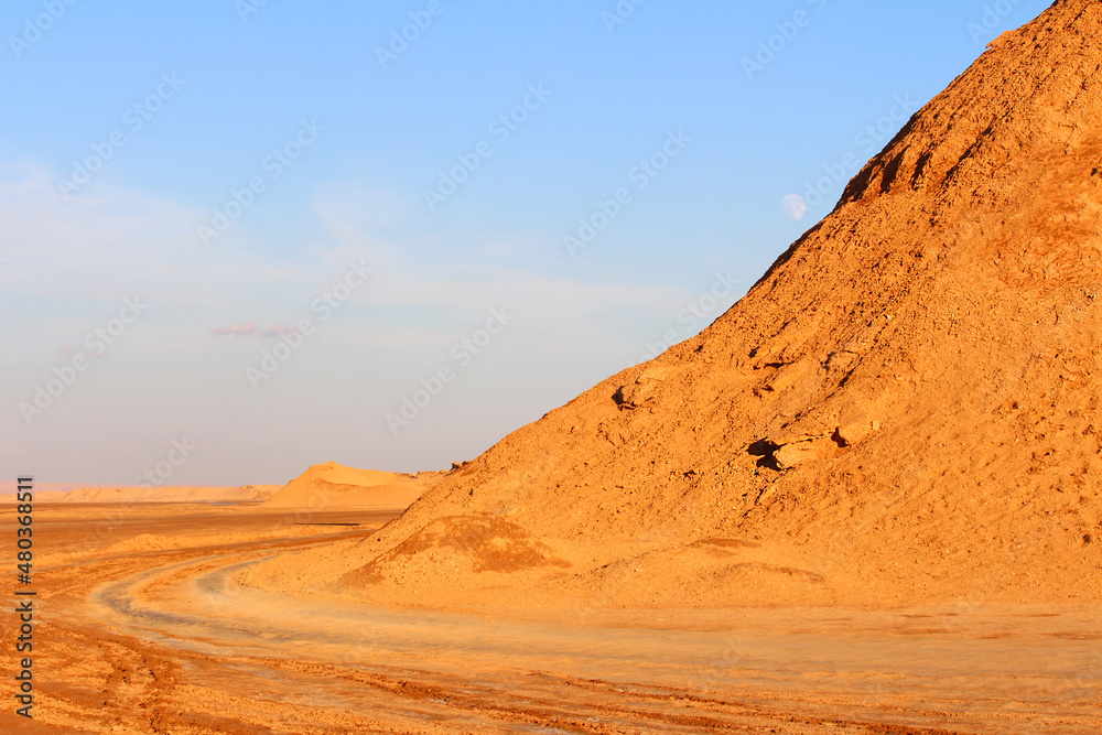 A mountain of sand in the Sahara Desert at sunset.