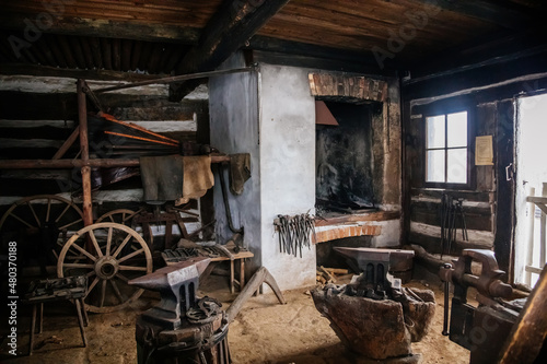 Kourim, Bohemia, Czech Republic, 26 December 2021: Interior of Traditional village house, country-style architecture, open-air ethnographic museum, forge with anvil hammers and pliers, iron horseshoes