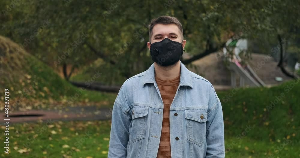 Man wearing protective face mask and keeping hand on his chest expressing gratitude Man wearing protective face mask and keeping hand on his chest expressing gratitude