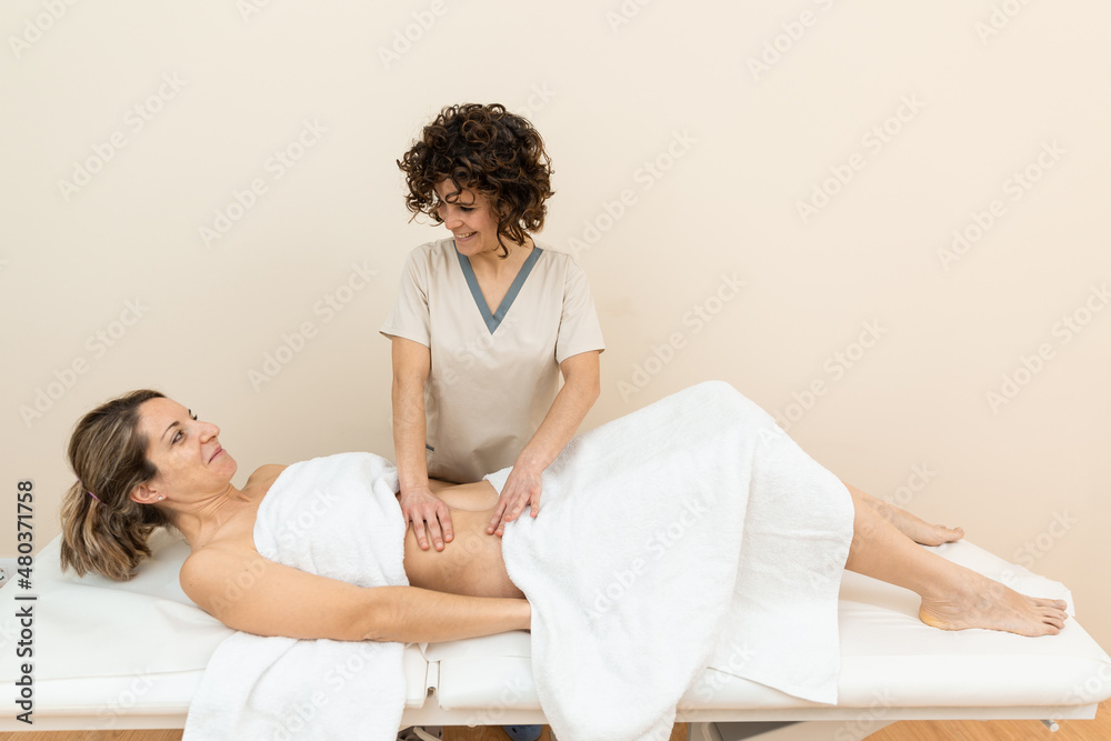 Fototapeta premium A therapist giving abdominal massage in female patient