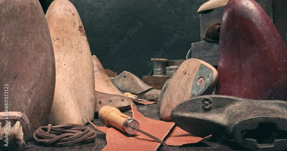 Traditional cobbler workplace with tools, strap, leather and rules. Traditional cobbler workplace with tools, strap, leather and rules.