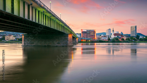 Linz, Austria. Cityscape image of riverside Linz, Austria at summer sunset with reflection of the city lights in Danube river. © rudi1976