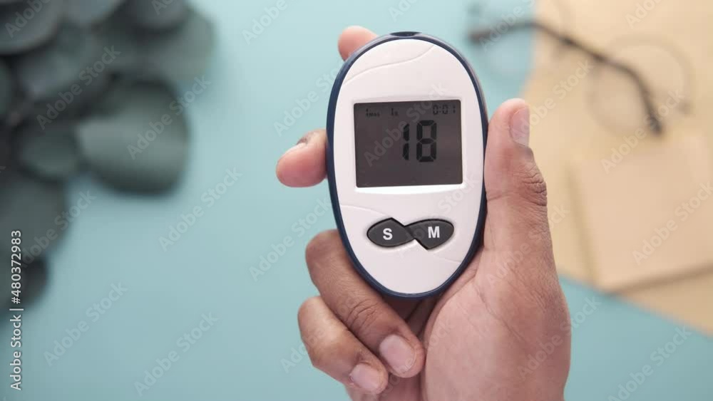 man's hand measuring blood sugar level man's hand measuring blood sugar level
