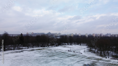 Flying over a sports field in a snow-covered city park. Aerial photography. © f2014vad