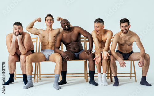 group of multiethnic men posing for a male edition body positive beauty set. Shirtless guys with different age, and body wearing boxers underwear