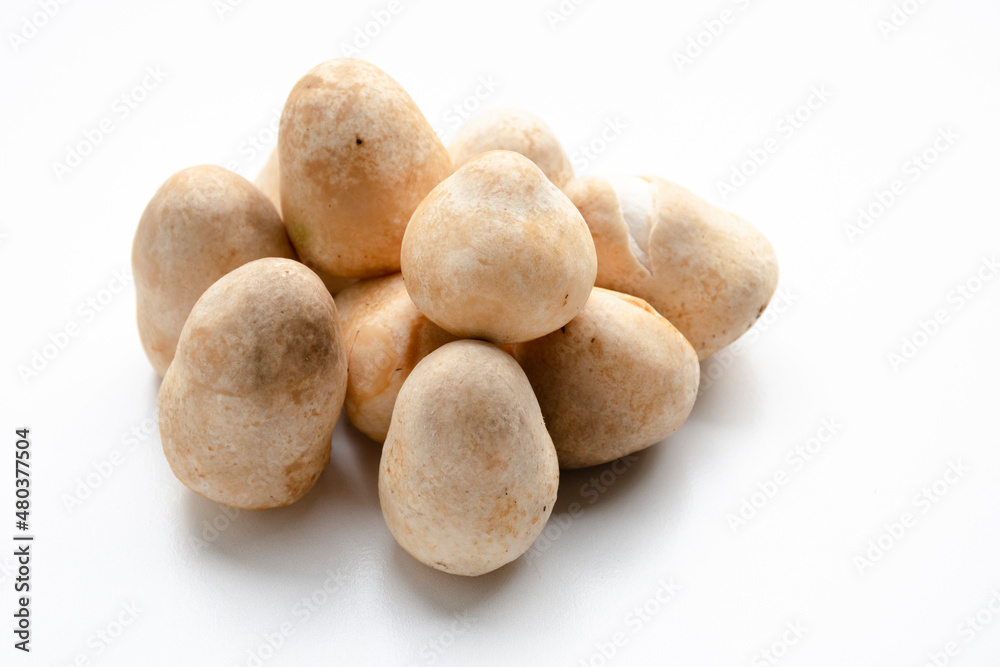 A group of exotic Straw mushrooms puts on a white background. A group of exotic Straw mushrooms puts on a white background.
