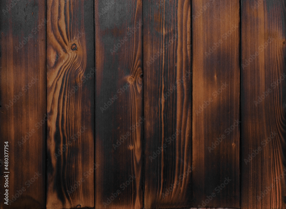 natural wooden brown background. burnt dark boards. 