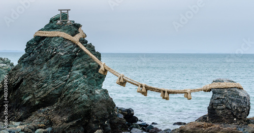 The famous Meotoiwa rocks, representing man and woman joined by a rope, on the coast of Ise, Japan photo