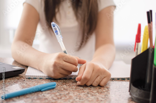 woman writing on a notebook