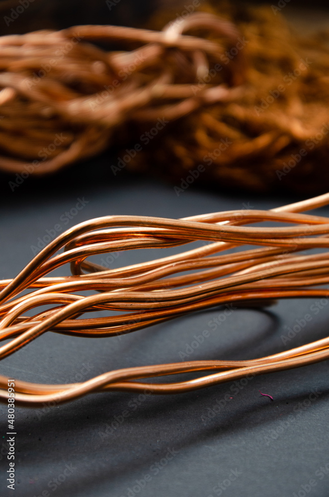 Cuprum. copper in coils, a lot of copper for the background. color and texture of copper wire on a dark background