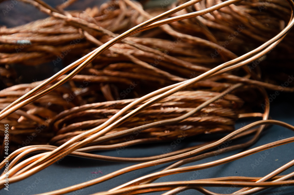 Cuprum. copper in coils, a lot of copper for the background. color and texture of copper wire on a dark background Cuprum. copper in coils, a lot of copper for the background. color and texture of copper wire on a dark background