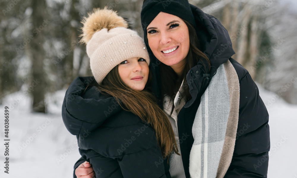 Handsome mother and his daughter are having fun outdoor in winter Handsome mother and his daughter are having fun outdoor in winter