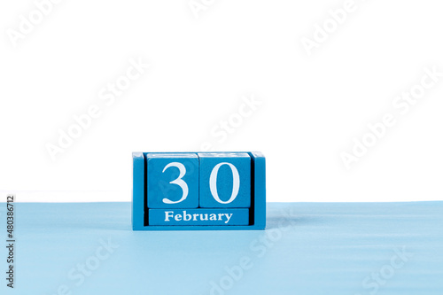 Wooden calendar February 30 on a white background