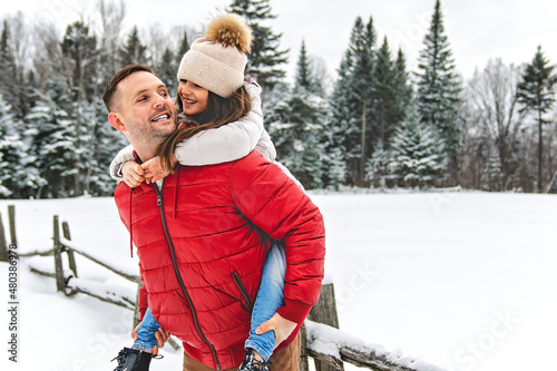 Handsome dad and his daughter are having fun outdoor in winter