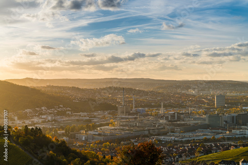 Obraz na płótnie Germany, Stuttgart city panorama landscape view above industrial quarter and mountains, houses, streets at sunset in warm orange light w salonie