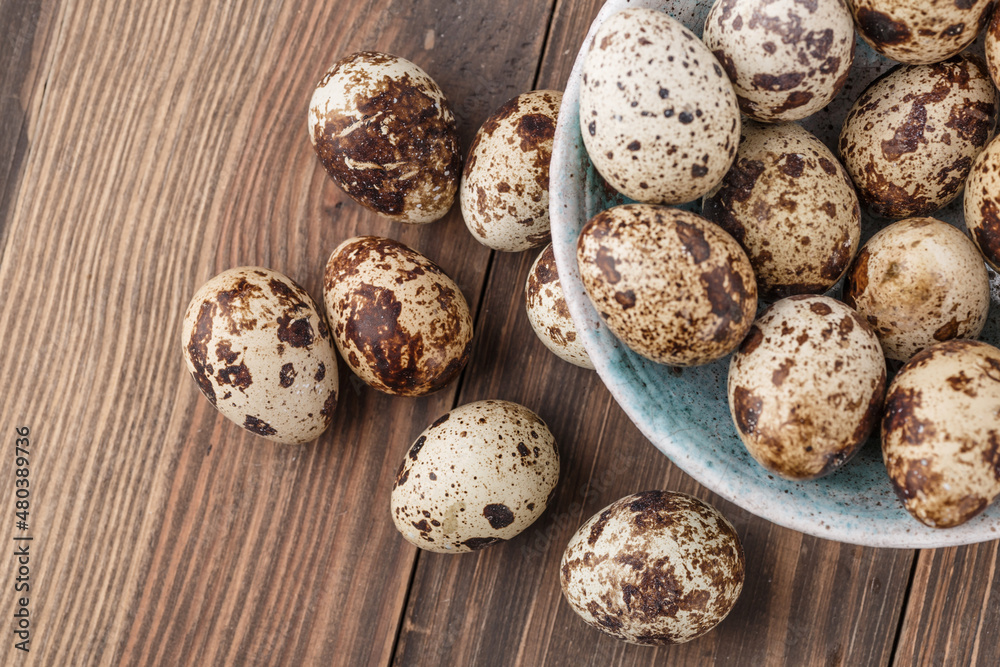 Quail eggs on the wooden plate. Quail eggs can be consumed by frying or boiling. In Indonesia quail eggs called telur puyuh.