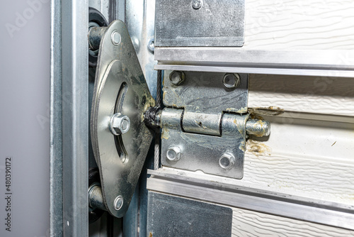 Grease lubricated double rollers in the guide for the backyard garage door, view from the inside. photo