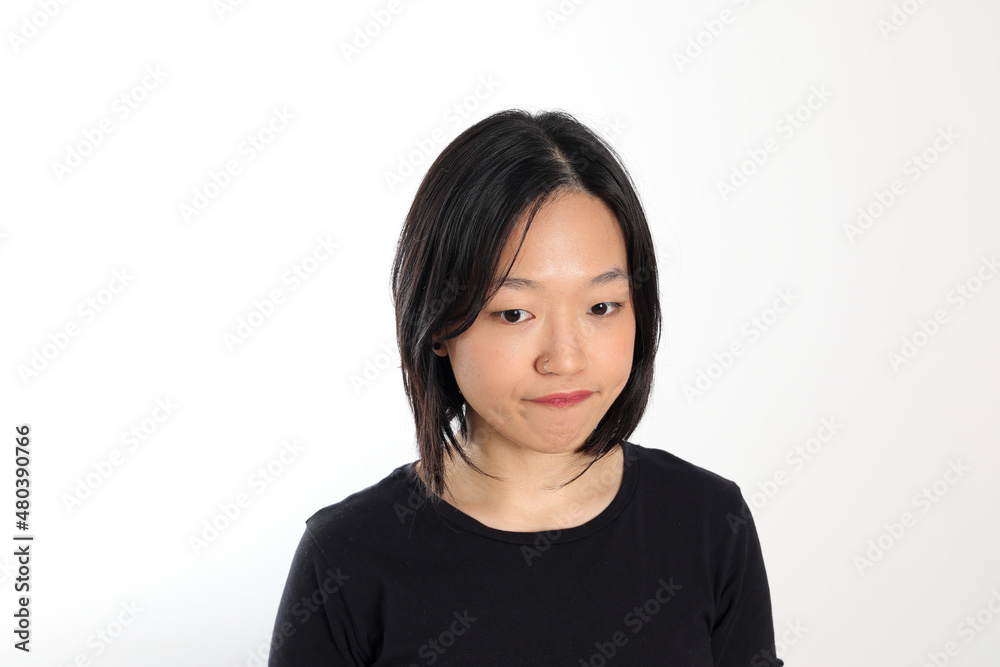 Young attractive south east asian woman pose face expression emotion on white background think Young attractive south east asian woman pose face expression emotion on white background think
